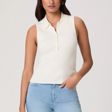 Woman wearing a white sleeveless sweater and light blue jeans against a plain background