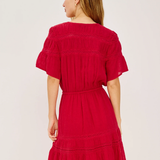 Red dress worn by a person on a white background