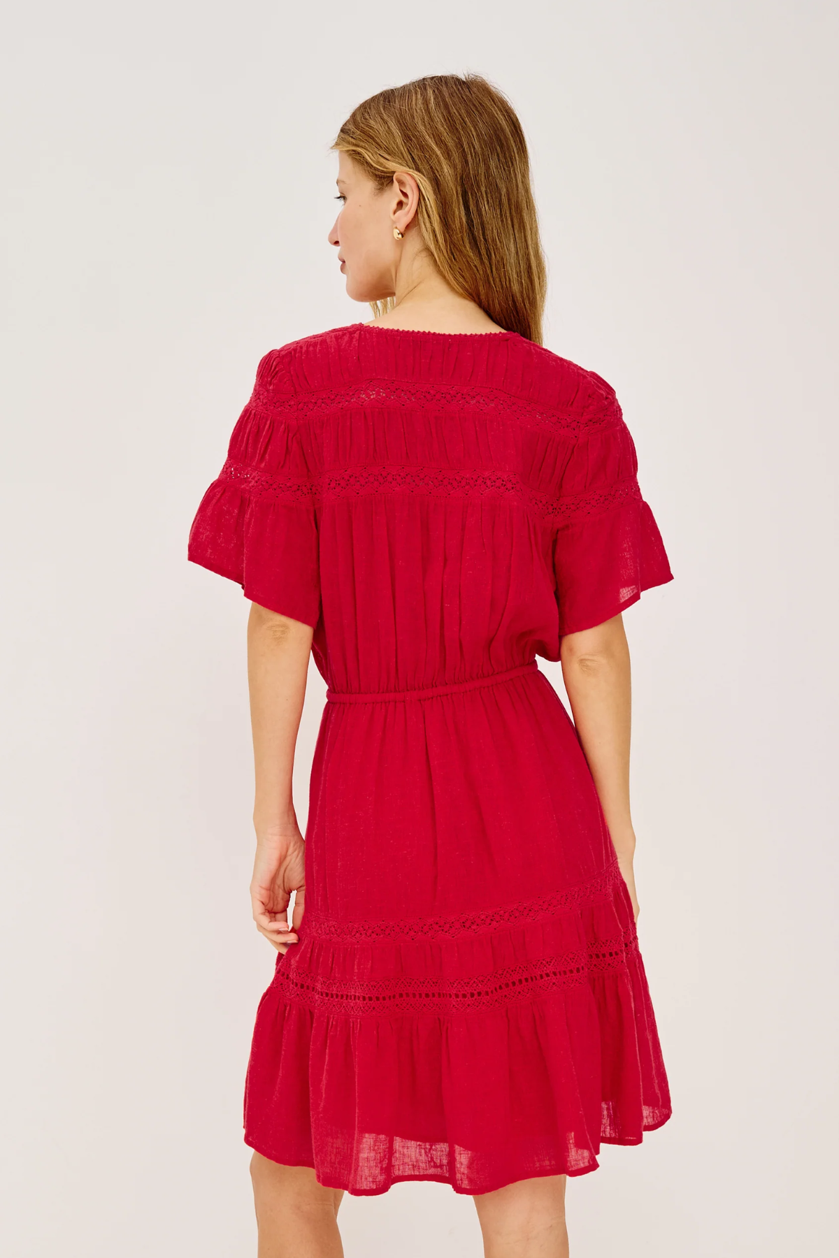 Red dress worn by a person on a white background