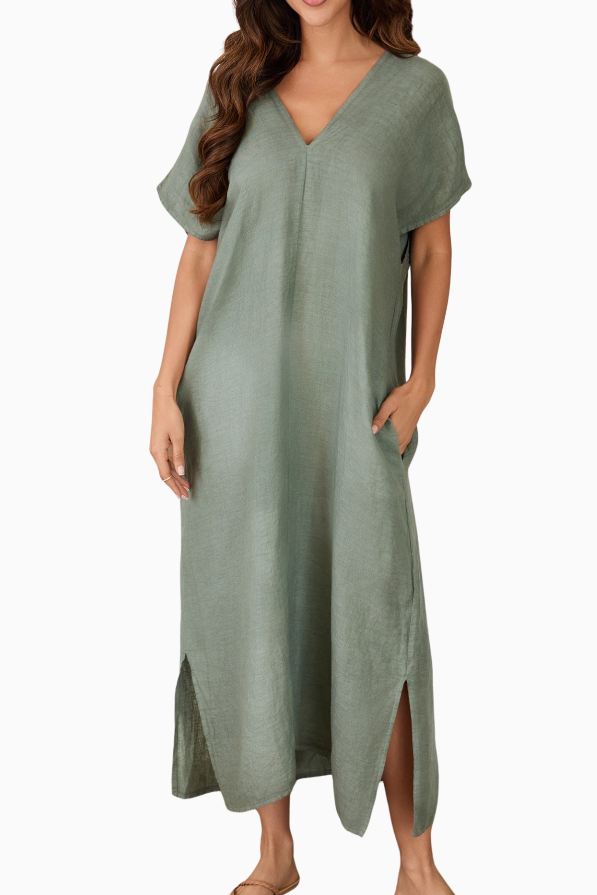 Woman wearing a green dress with a plain background