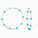 Gold hoop earrings with turquoise beads on a white background