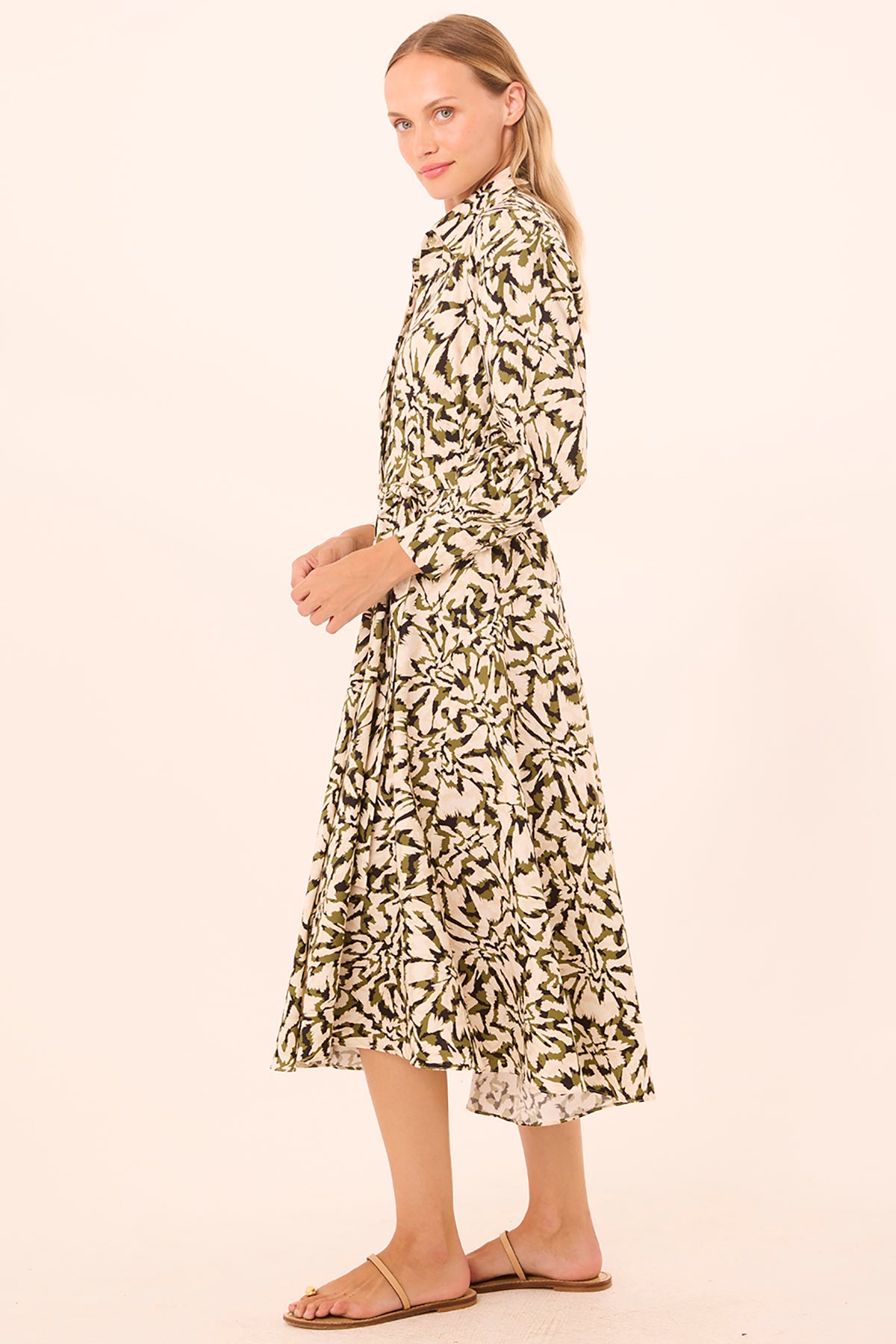 Woman wearing a patterned dress on a beige background