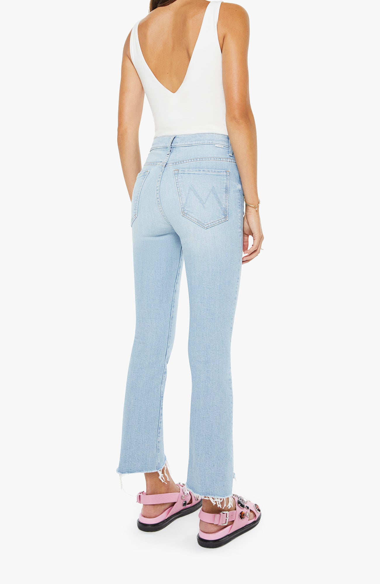 Light blue jeans worn by a person on a white background