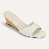 White sandal with a wedge heel on a white background