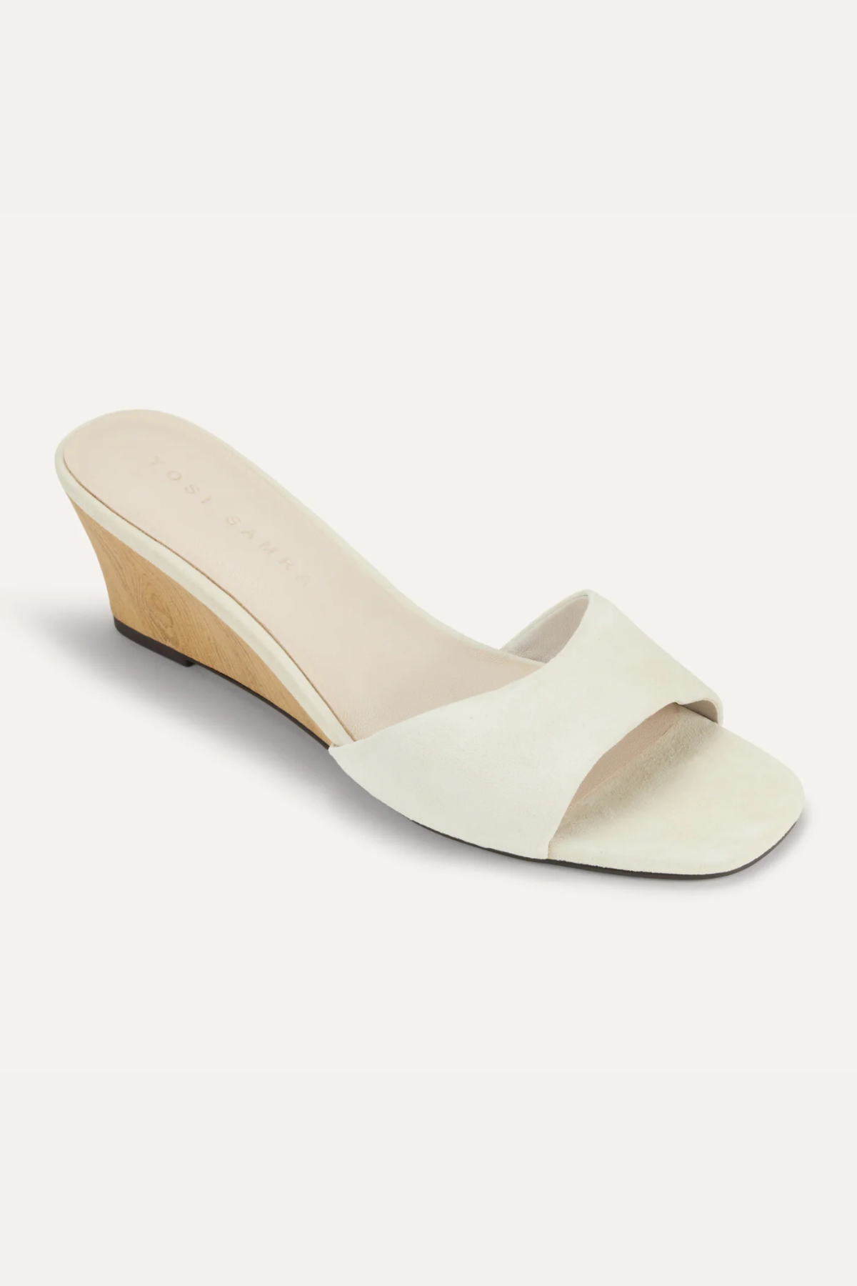White sandal with a wedge heel on a white background