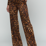 A model wearing a brown and black leopard print jumpsuit with wide legs, shown from the waist down against a light gray studio background.