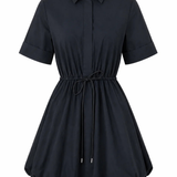A short-sleeve collared shirt dress in black, featuring a button-down front, cuffed sleeves, and a drawstring tie at the waist, shown against a plain white background.