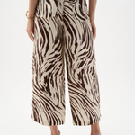 Zebra print pants worn by a person on a white background