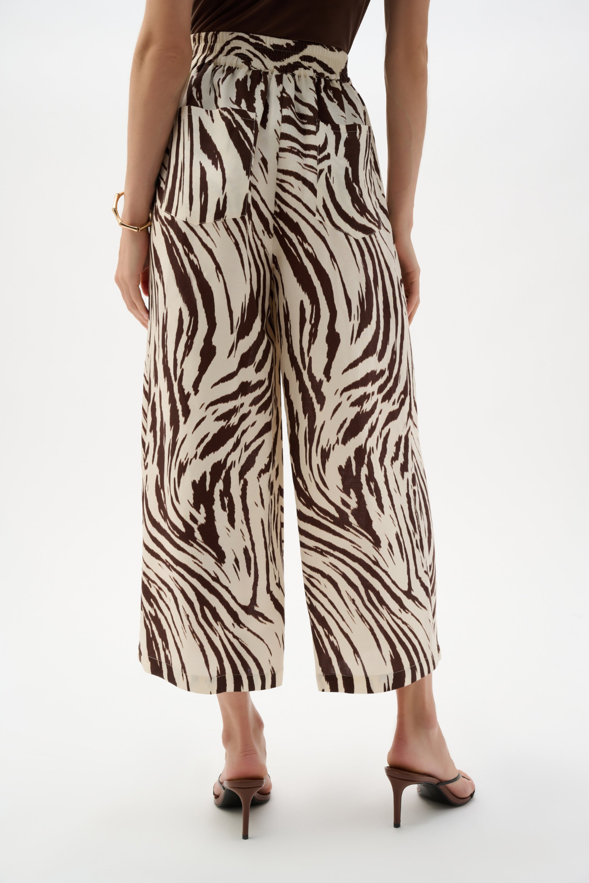 Zebra print pants worn by a person on a white background