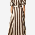A woman viewed from the back wearing a midi dress with vertical brown and cream stripes, short puff sleeves, and a matching belt, against a plain light gray background.