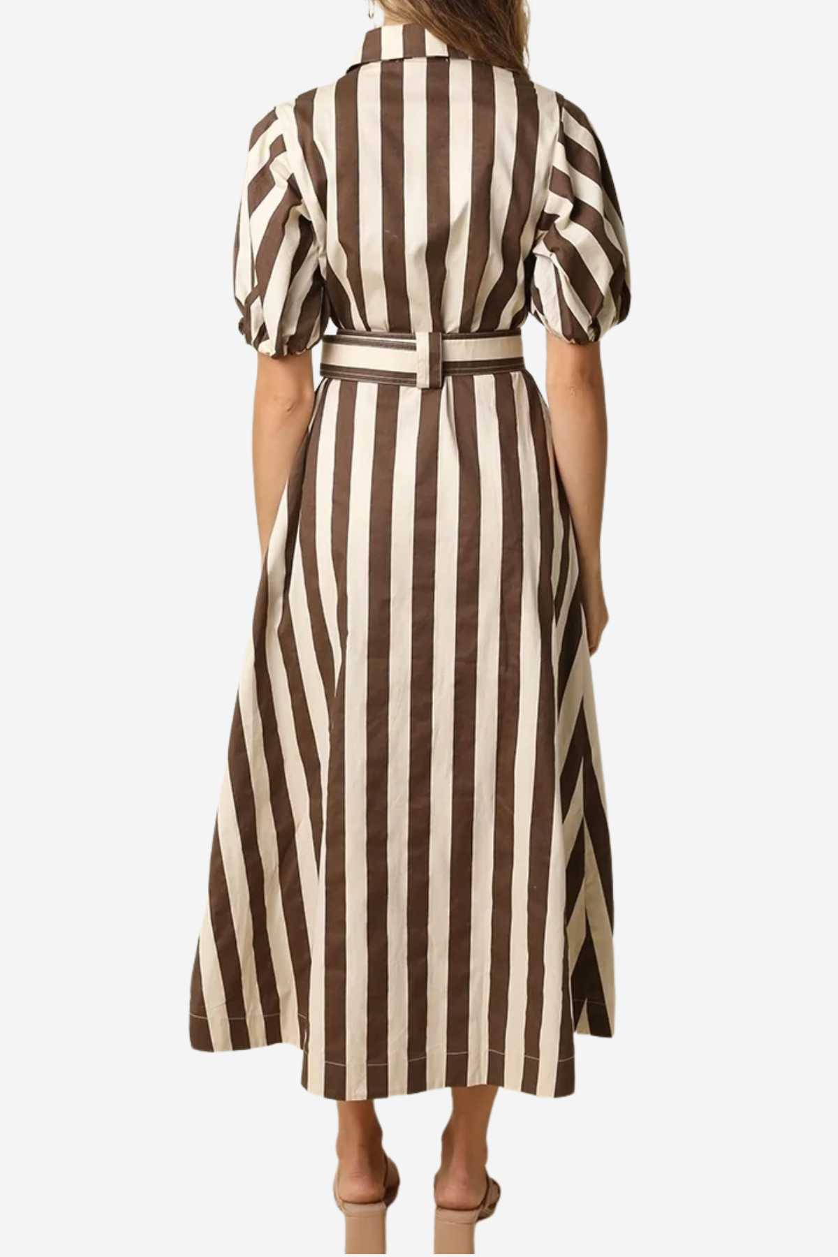 A woman viewed from the back wearing a midi dress with vertical brown and cream stripes, short puff sleeves, and a matching belt, against a plain light gray background.