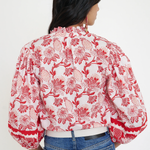 red printed long sleeve blouse  modeled against a white background