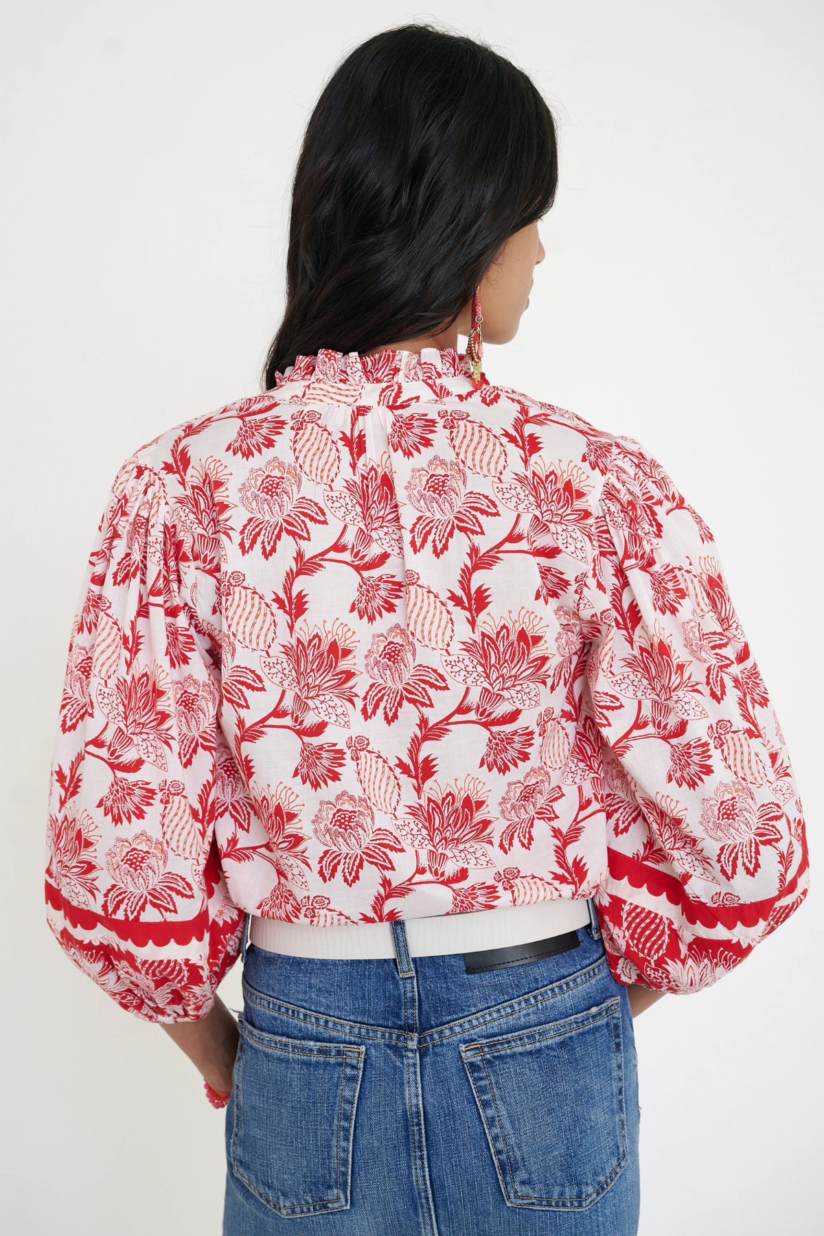 red printed long sleeve blouse  modeled against a white background