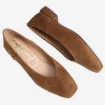 A pair of women's brown suede flats with square toes, shown from top and side angles on a light gray background. The brand name 'Jean Schlumber' is visible on the insole.