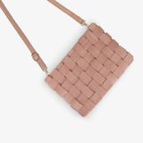 A woven rectangular crossbody bag in a dusty rose pink color, featuring a matching shoulder strap and small gold-tone hardware, shown against a plain light gray background.