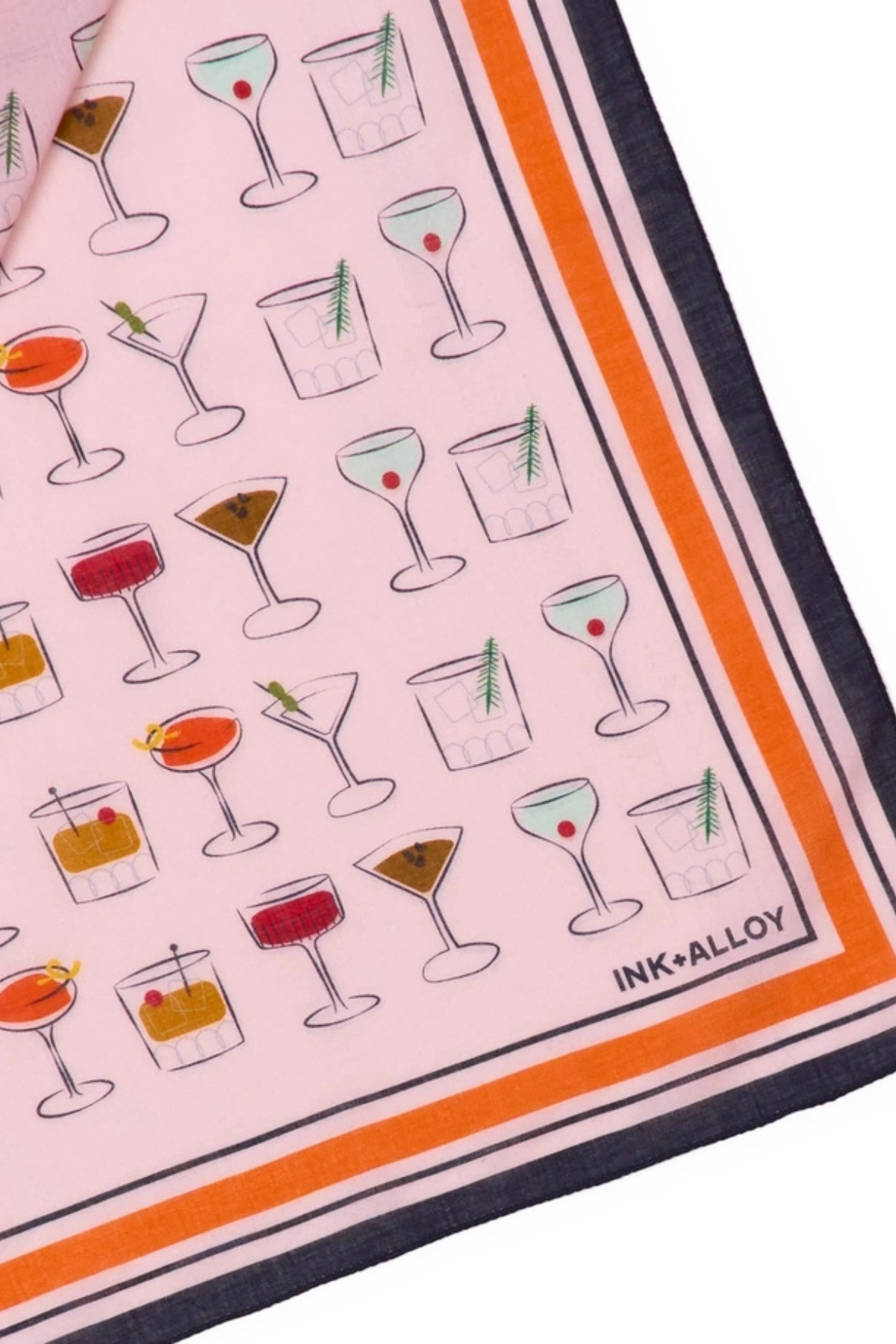 A close-up of a square scarf featuring a light pink background printed with various cocktail illustrations. The scarf has a bold orange stripe border, a dark navy blue border, and the brand name 'INK*ALLOY' printed in the bottom right corner.