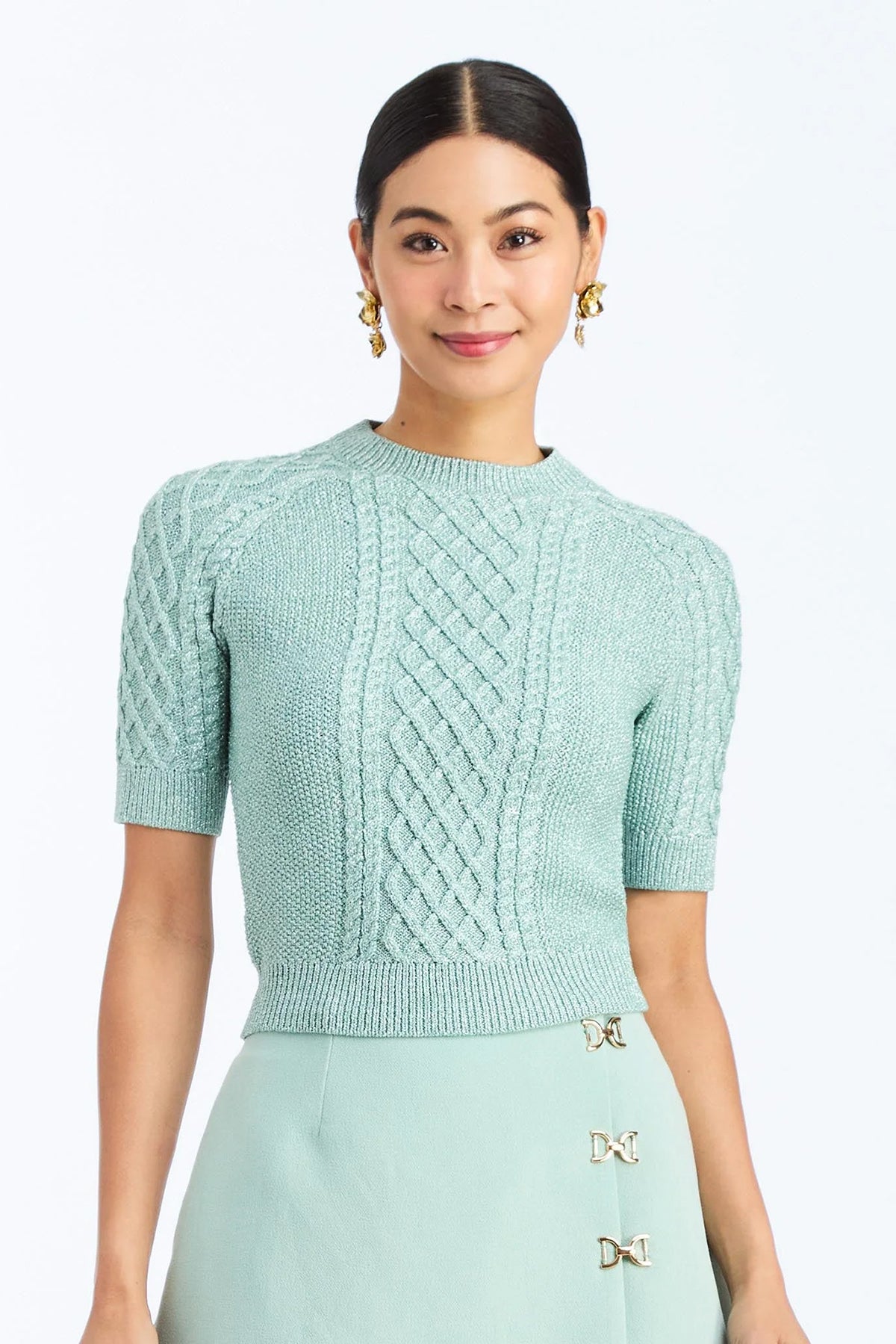 Woman wearing a soft mint cable knit sweater with a smooth, lightweight knit and polished neckline
