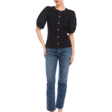 Woman wearing a black top and blue jeans on a white background