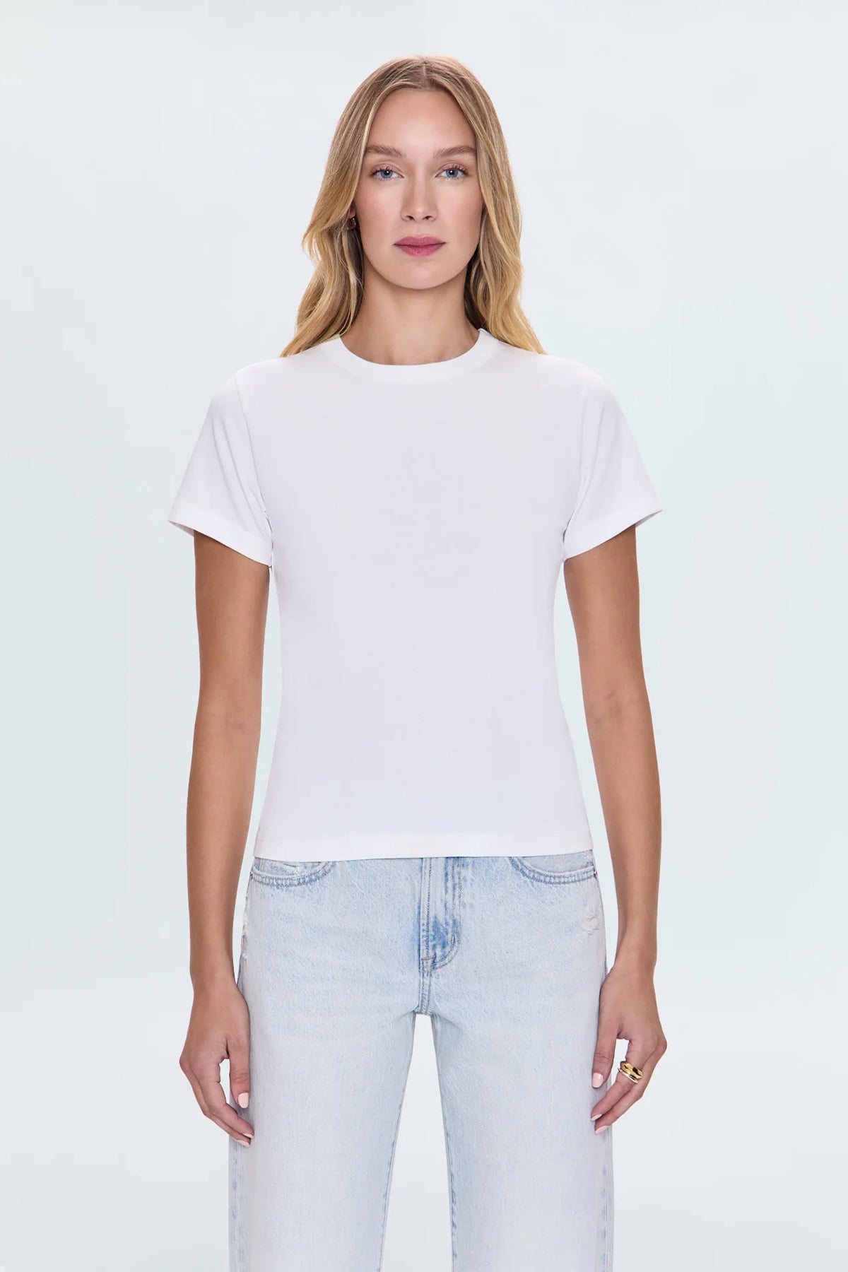 Minimal white top with a clean neckline and streamlined fit.