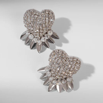 Heart-shaped earrings with rhinestone details on a light gray background