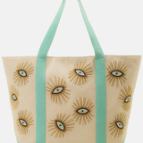Beige tote bag with sunflower designs and green straps on a white background