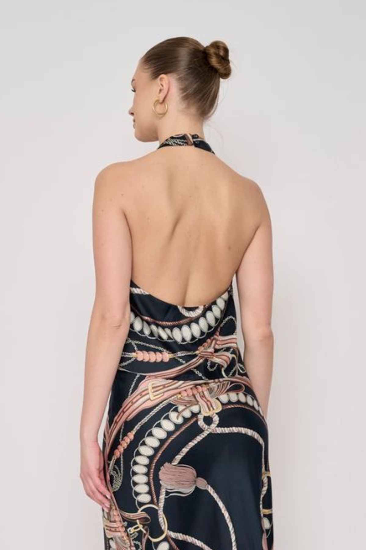 Model wearing a sleeveless printed halter top with a coordinating floral-inspired pattern and relaxed silhouette.