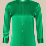 Green satin shirt on a beige background