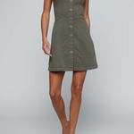 Model wearing green button front a-line dress on an off white background.