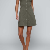 Model wearing green button front a-line dress on an off white background.