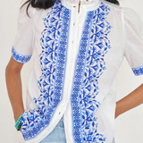 White top with blue printed detailing modeled on white background