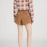 Person wearing a plaid shirt and brown shorts on a light gray background