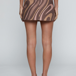 Model wearing a patterned low-rise mini skirt with a tailored silhouette and neutral tones.