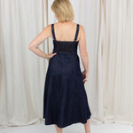 Indigo midi dress with a sweetheart neckline, corset-inspired seams, and a belted waist