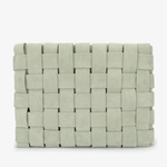 A woven rectangular clutch bag in a light sage green color, featuring a textured basketweave pattern, shown against a plain white background.