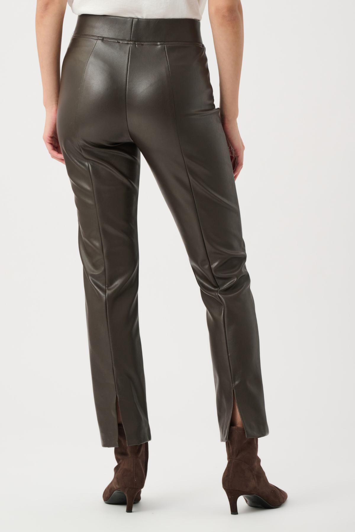 Brown leather pants worn by a person on a white background