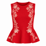 Red sleeveless top with white floral embroidery on a white background