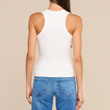 A woman shown from the back wearing a fitted white ribbed tank top and blue jeans against a plain beige studio background.