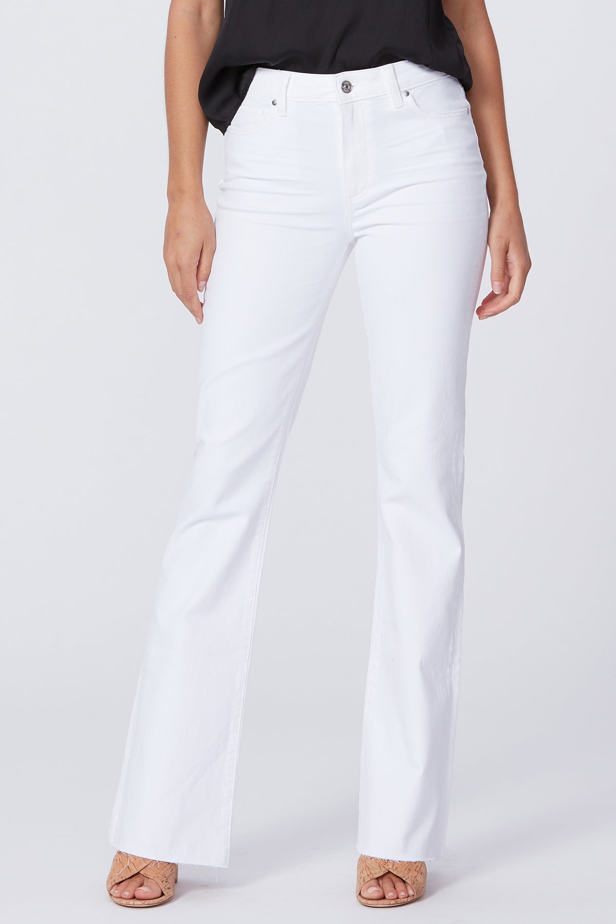 White jeans worn by a person on a white background
