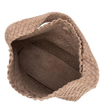 Brown woven basket with a textured surface on a white background