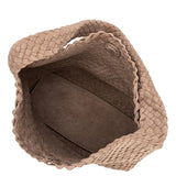 Brown woven basket with a textured surface on a white background
