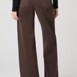 Brown wide-leg pants worn by a person on a white background