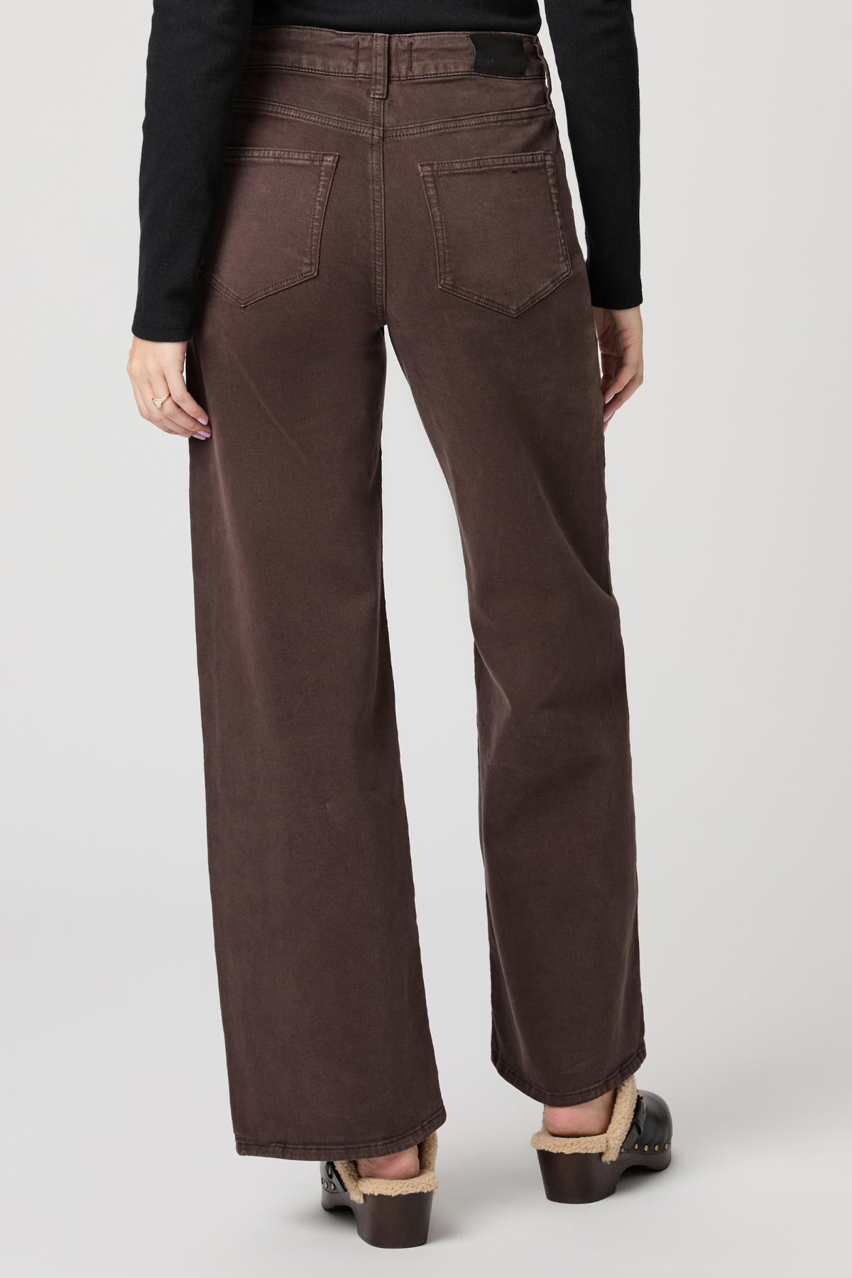 Brown wide-leg pants worn by a person on a white background