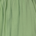 Close-up of a green skirt with a focus on texture and color.