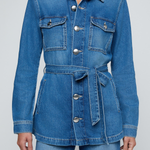 Model wearing a blue denim safari jacket with utility pockets and a button-front design.
