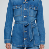 Model wearing a blue denim safari jacket with utility pockets and a button-front design.