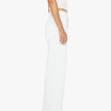 Person wearing a white sleeveless top and pants on a white background