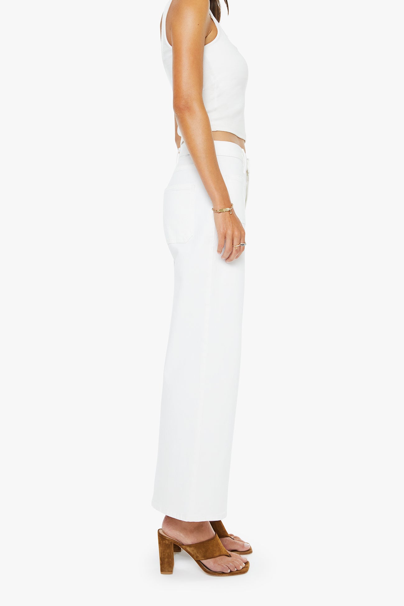 Person wearing a white sleeveless top and pants on a white background