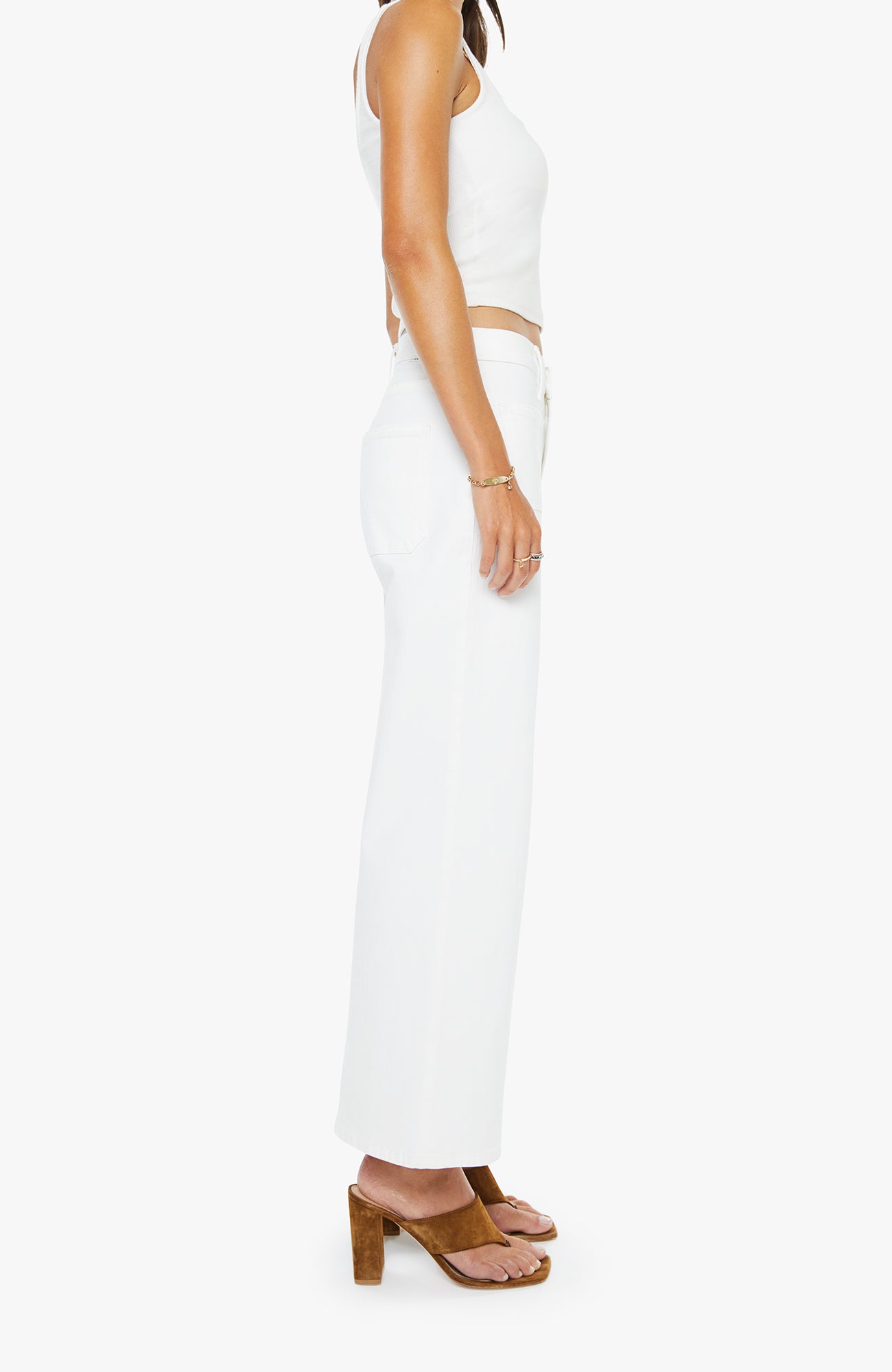 Person wearing a white sleeveless top and pants on a white background