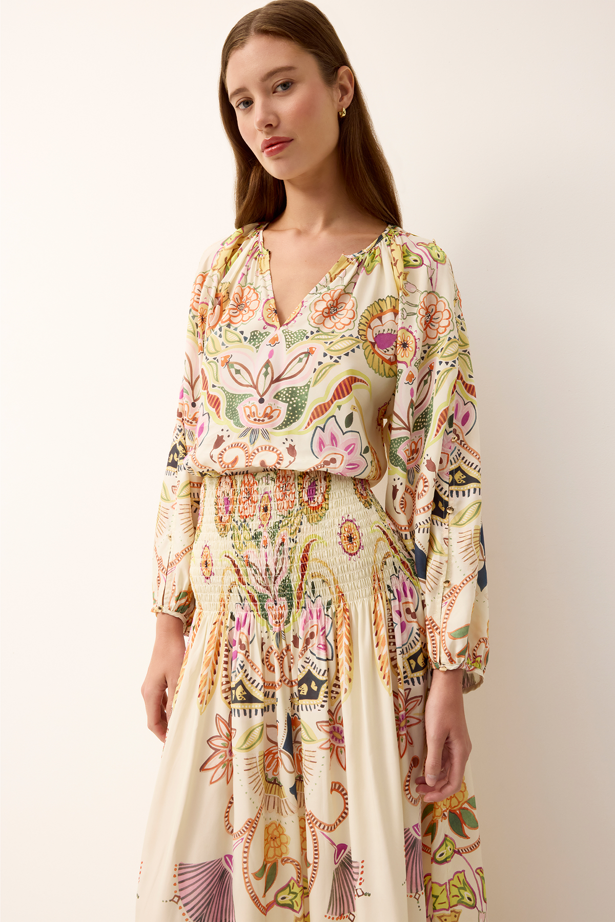 woman in printed long sleeve top on white background 