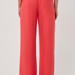 Person wearing bright red wide-leg pants on a light gray background